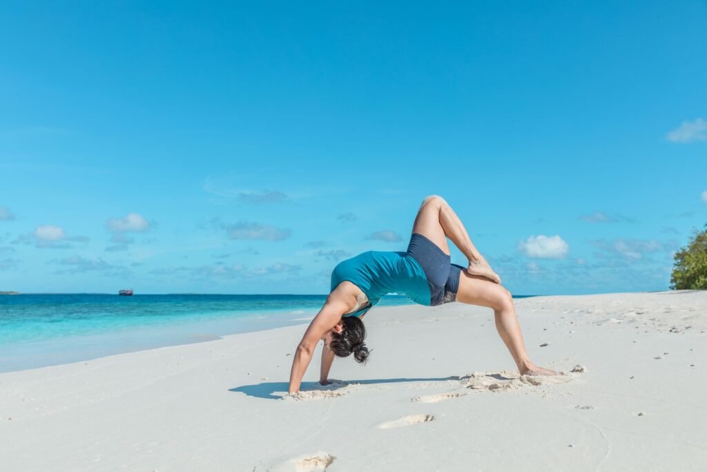 yoga on beach health and wellness