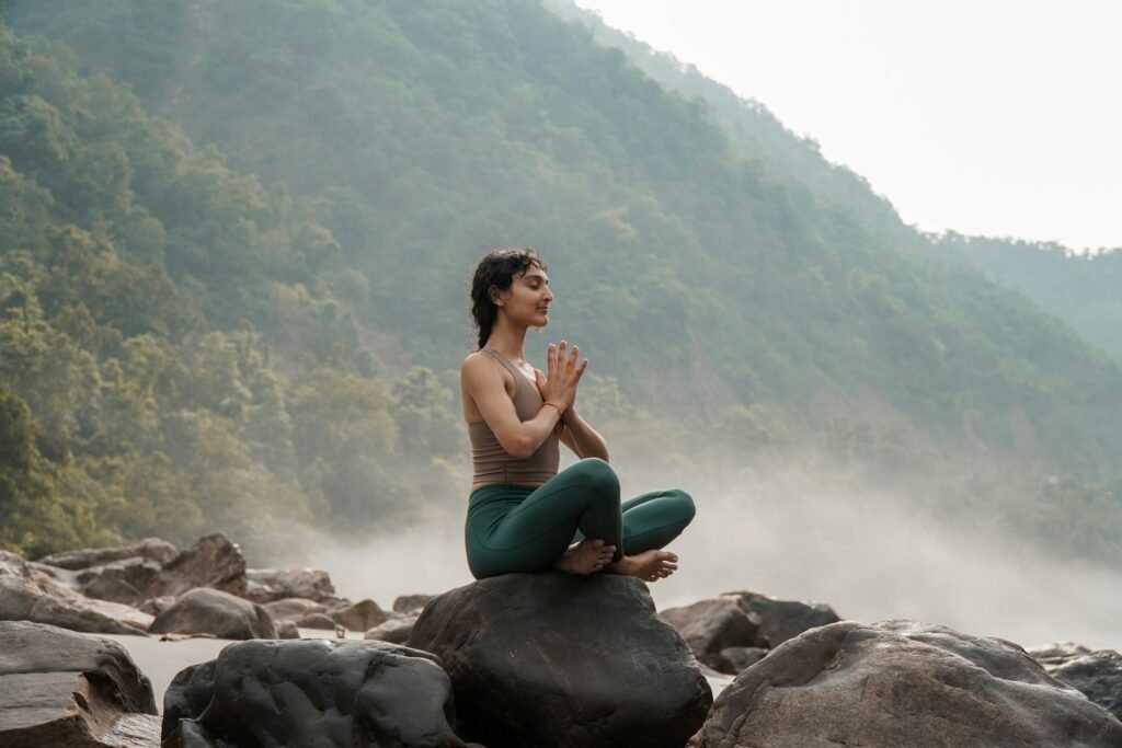 woman meditating by the coast