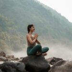 woman meditating by the coast