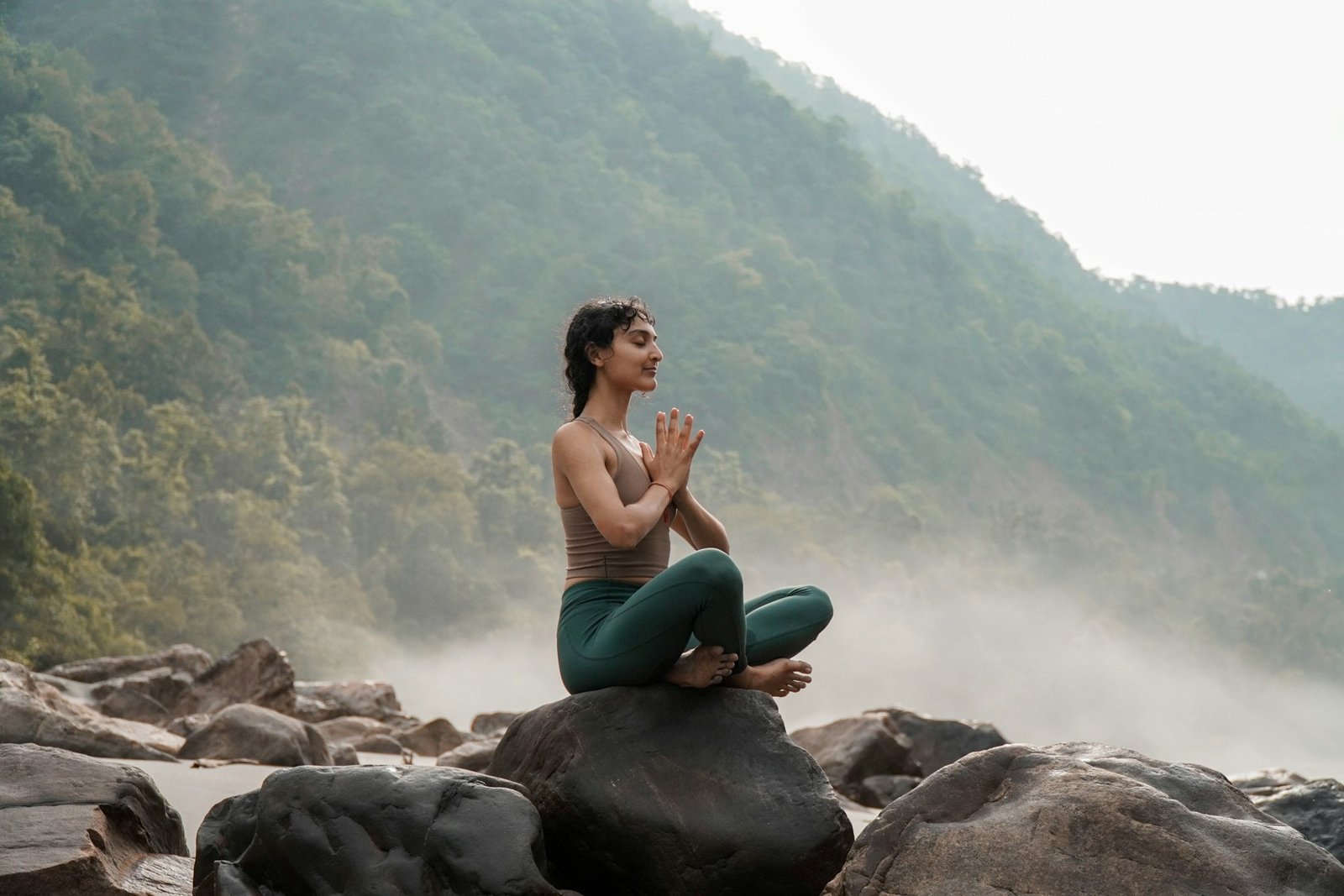 woman meditating by the coast