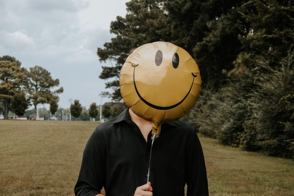 person with smiling balloon