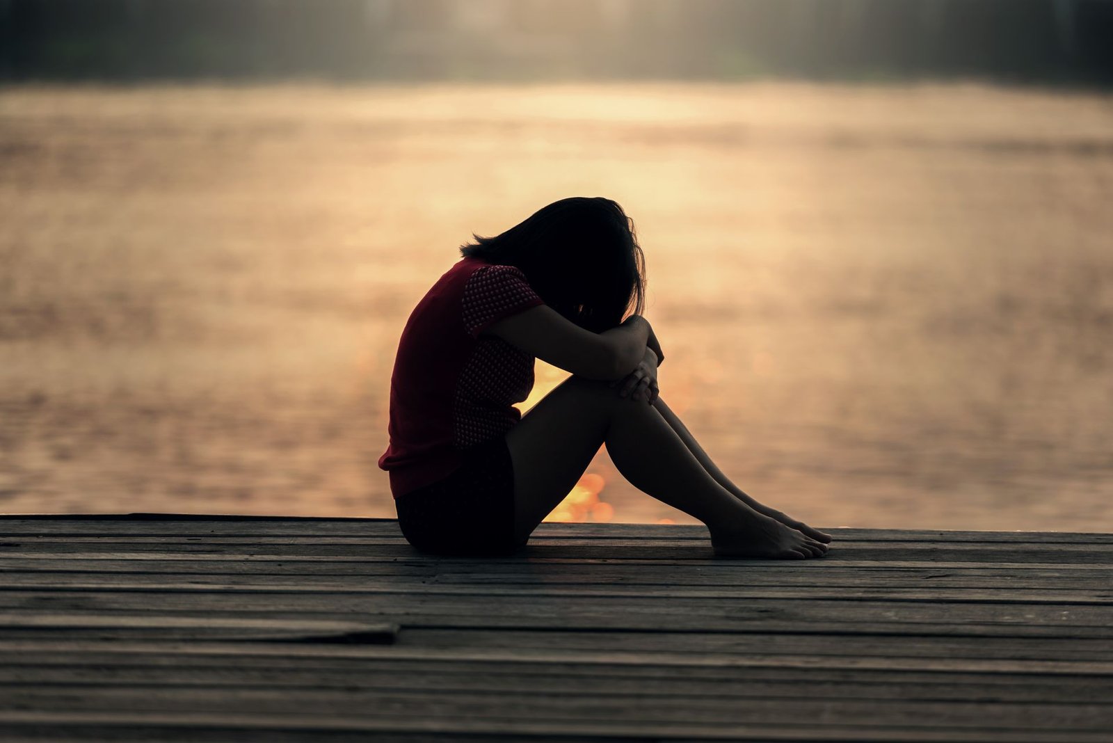 Sad woman by the water